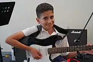 Gallery Music School, Young boy practicing guitar under the guidance of his instructor at Besharp Music School, Adelaide., clarinet lesson