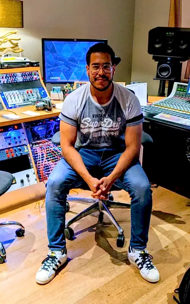 Children's music teacher at Besharp Music School in Adelaide, guiding young students in a recording studio.